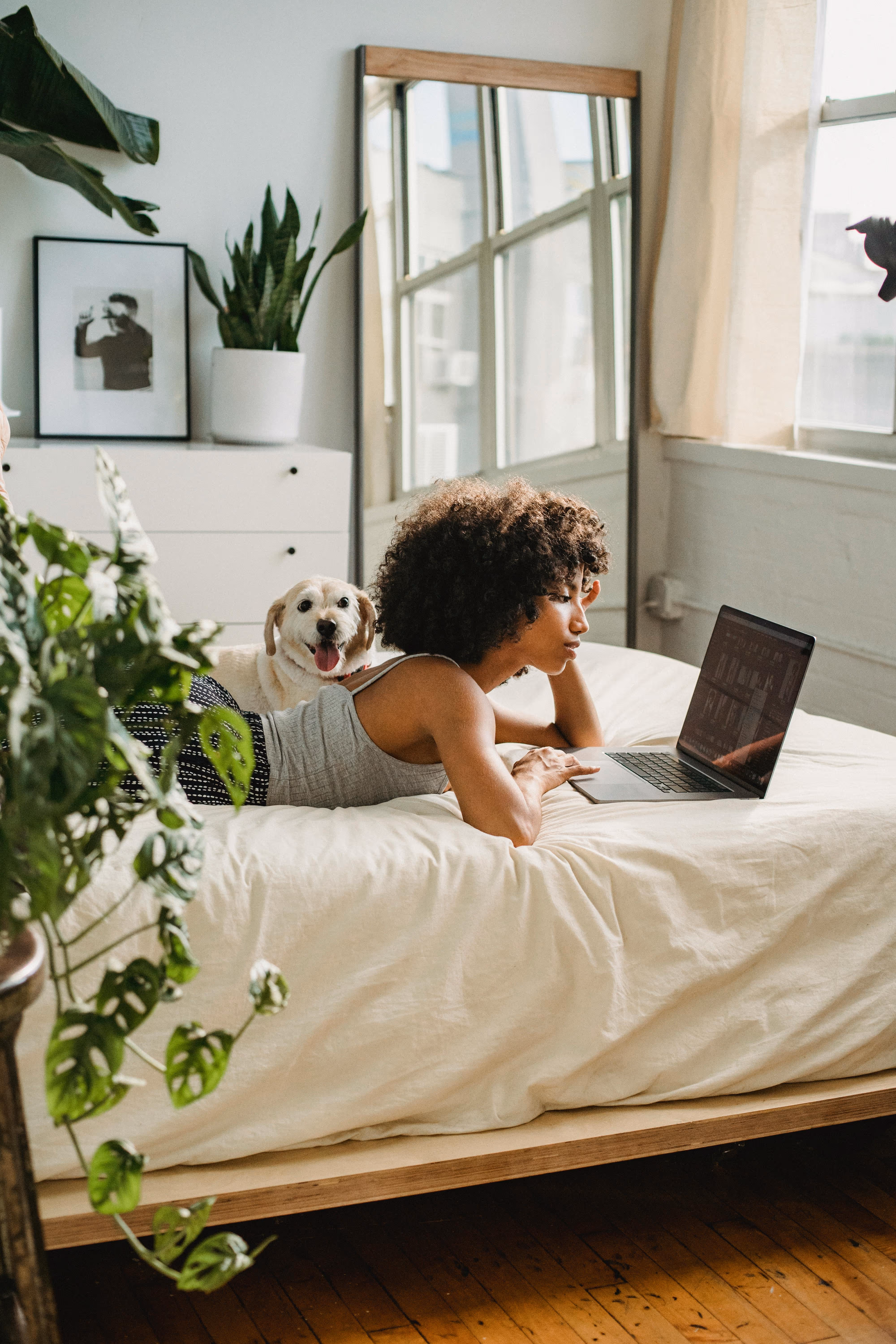 Women laying bed with dog stock image