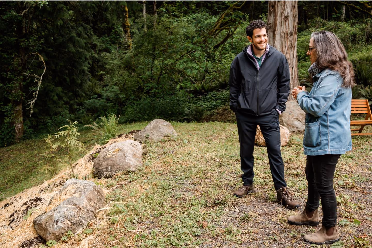 An Earth teammate standing with a customer in the woods at the Olympic Peninsula in Washington state