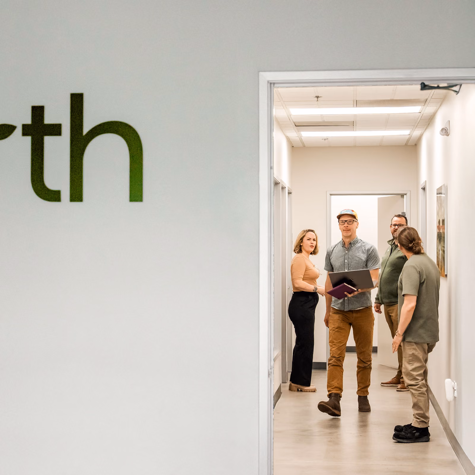 An Earth scientist and a few Earth employees in a hallway in our Las Vegas facility.