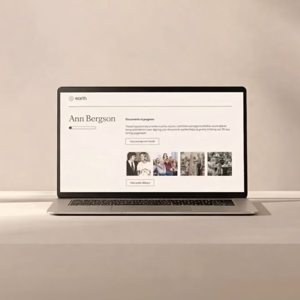 A laptop computer with an Earth Funeral Obituary open on it