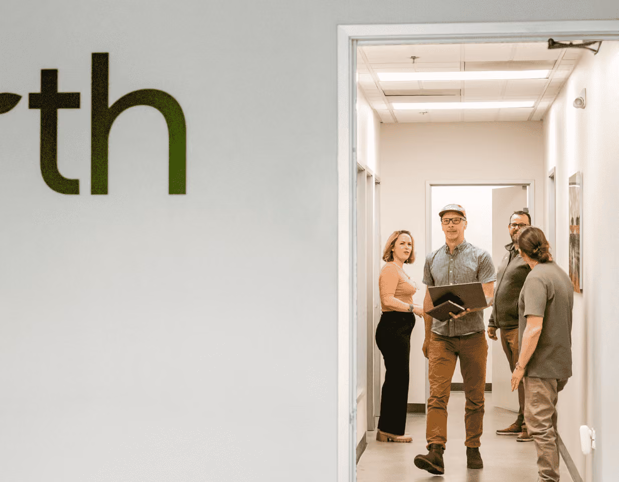 Earth Funeral leadership and team members in a facility hallway