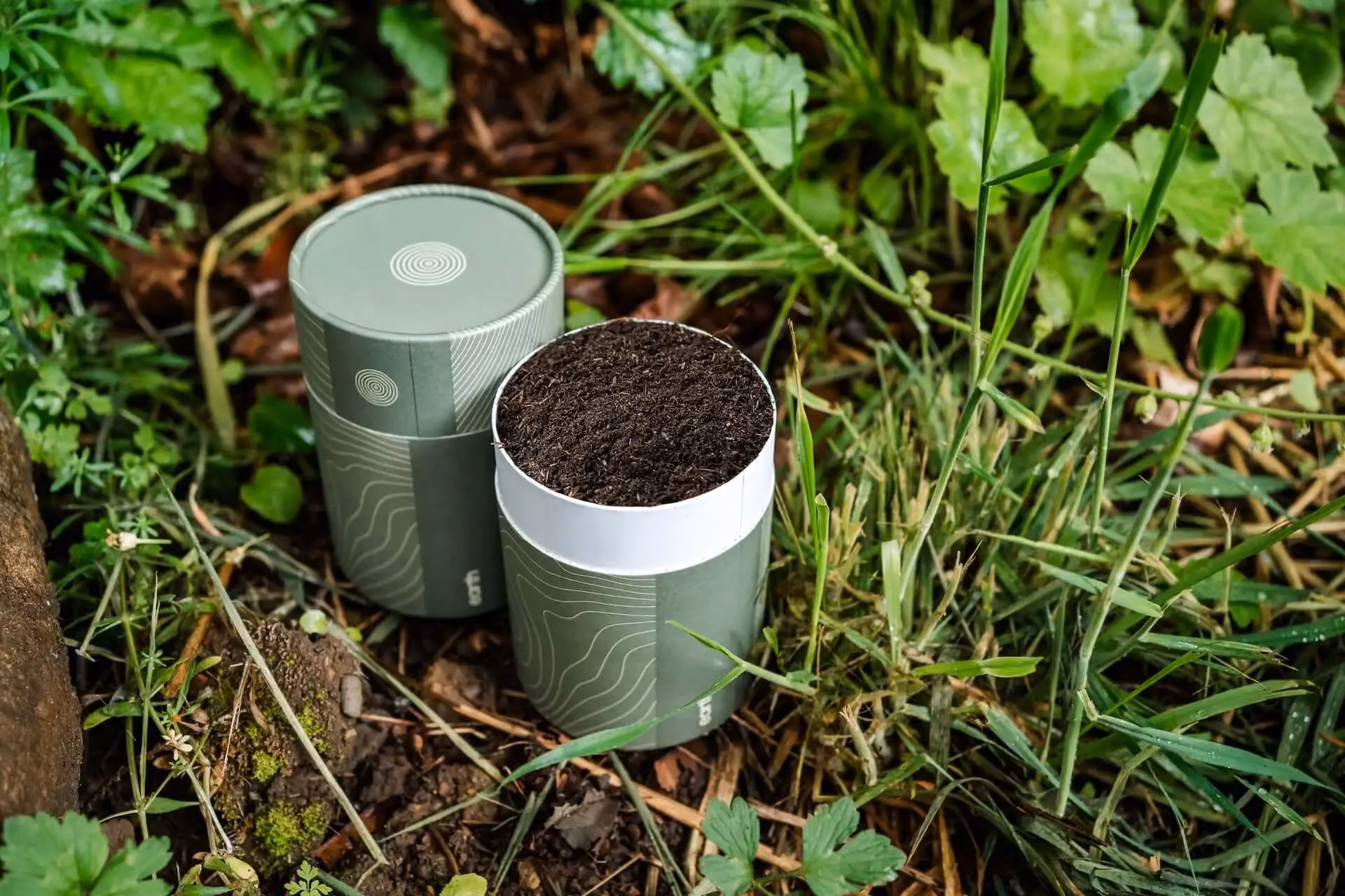 Earth Funeral's biodegradable soil container containing human composting soil.