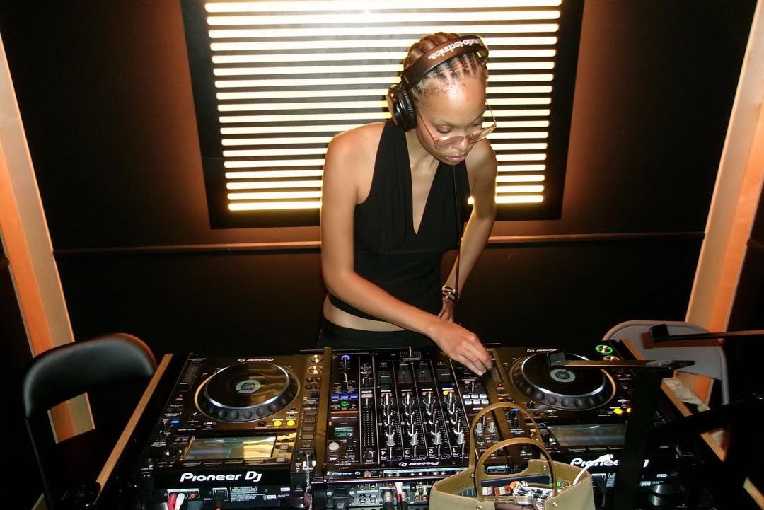 Dom Supremacy is standing at a Pioneer Mixer playing an event for this artist portrait.