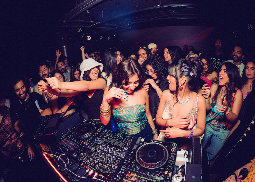 Dom Supremacy is standing at a Pioneer Mixer playing an event for this artist portrait.