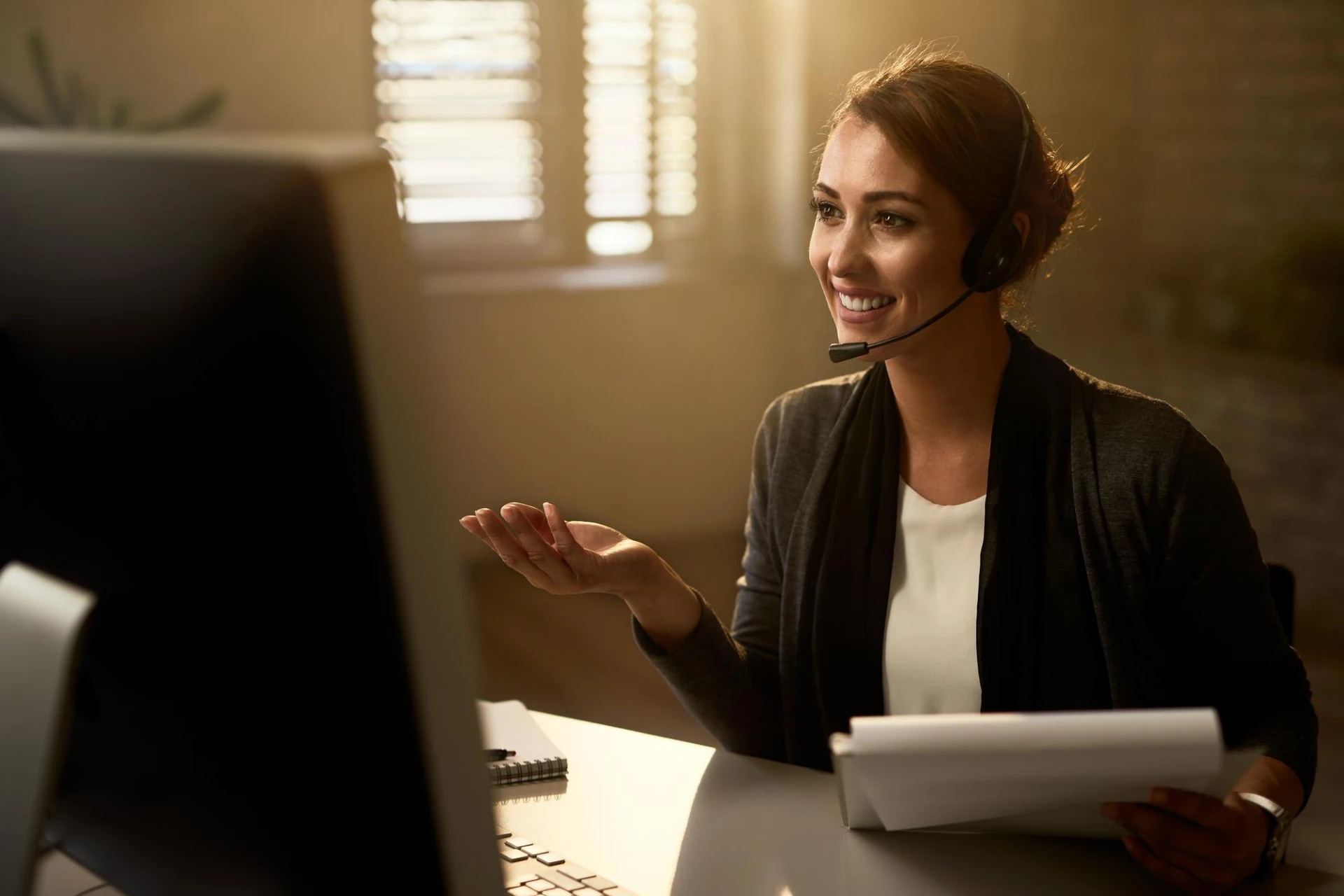 Customer service rep smiling while reviewing call logs