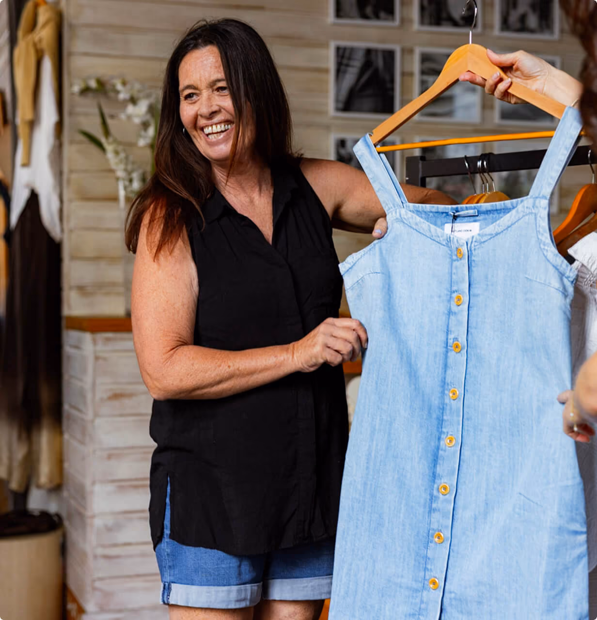 A Thread Together client choosing a new dress at a Clothing Hub