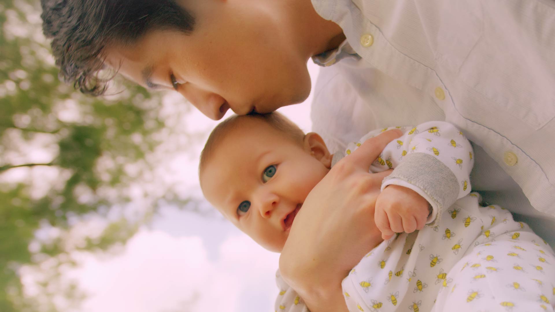 Outdoor family lifestyle B-Roll photo still of Lancaster PA joyful father holding baby