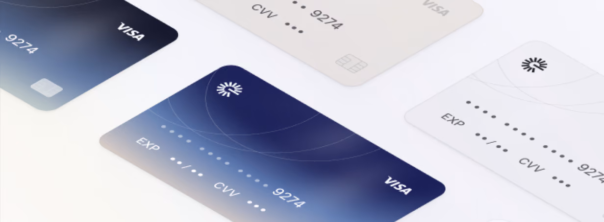Close-up of several modern Visa credit cards in dark blue and white with blurred numbers and expiration dates.
