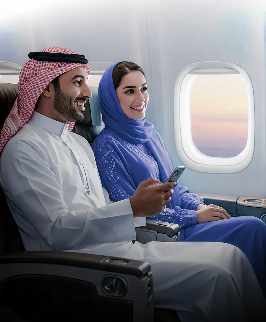A Saudi woman and man sitting in an airplane