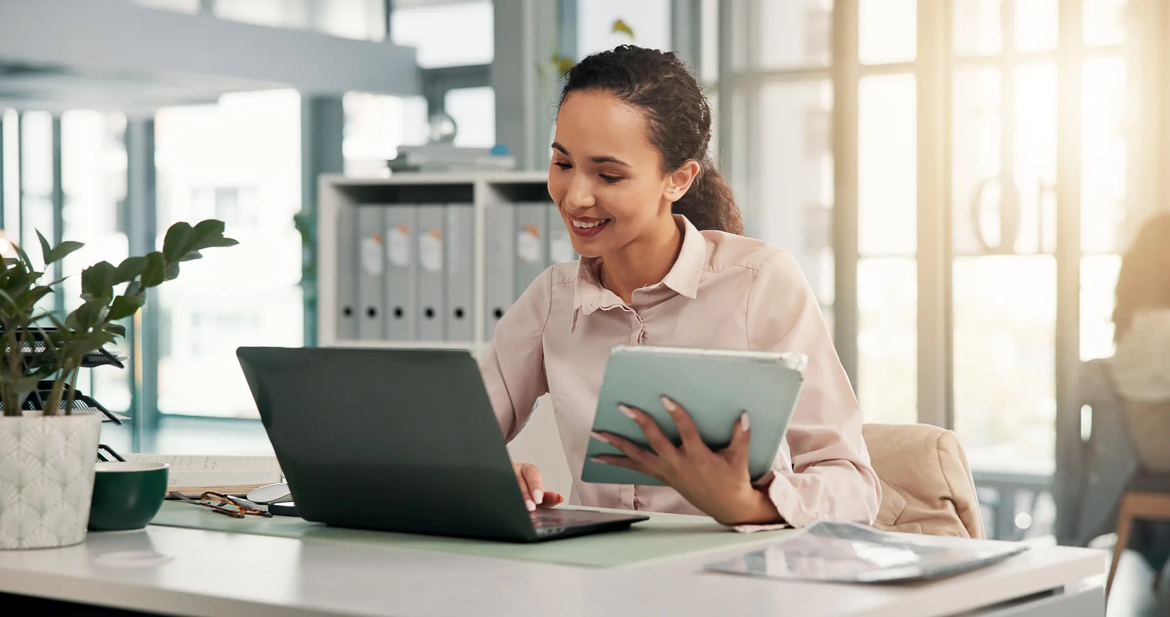 A team reviews reports around a laptop displaying a data dashboard.