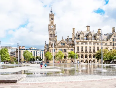 Bradford City Hall clock tower and civic buildings beside the fountain pool in City Park