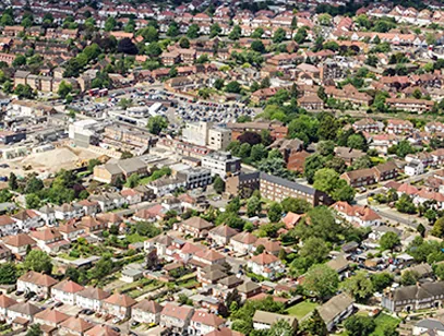 Aerial view of red-brick suburban streets and a town centre in Hounslow