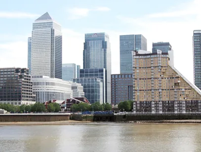 Canary Wharf glass towers and apartment blocks across the River Thames in London