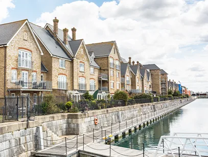 Brick townhouses overlooking a quiet marina waterside in Medway