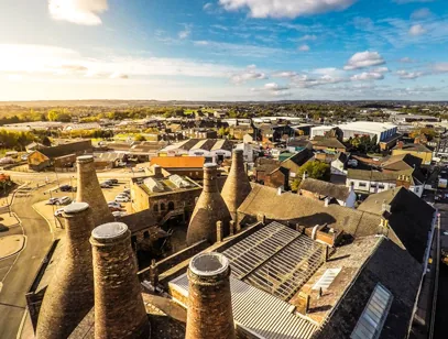 Rooftop view of traditional brick pottery bottle kilns above the town in Stoke-on-Trent