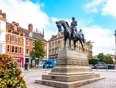 Equestrian statue on a stone plinth in a city square with historic buildings in Wolverhampton