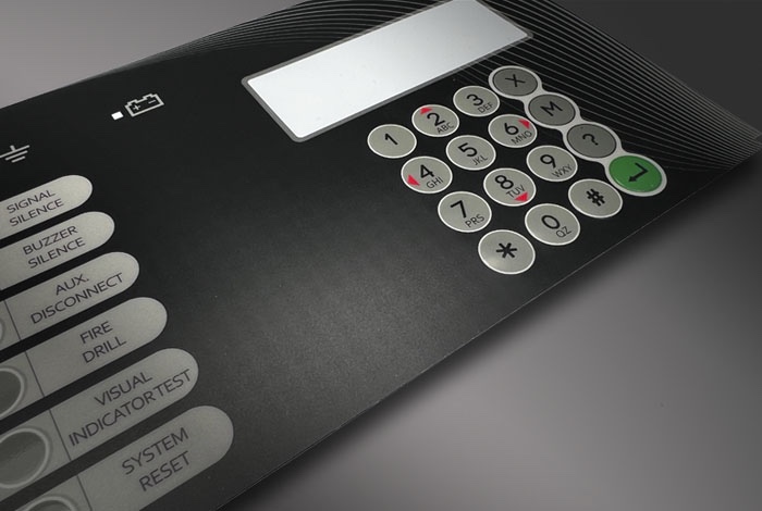 Printed graphic overlay forming the operator-facing panel of a membrane switch keypad