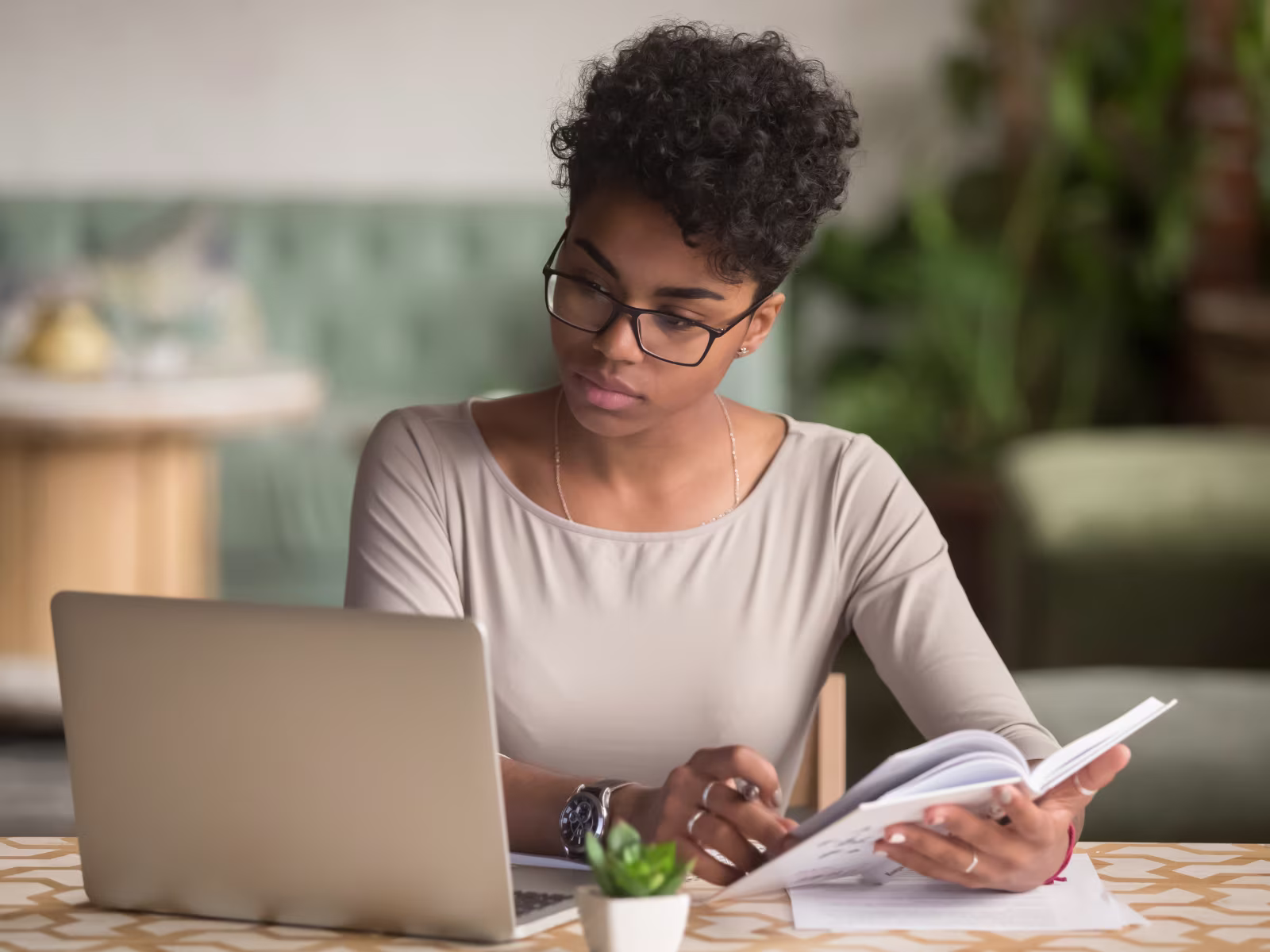 Business professional researching prospects while working on a laptop