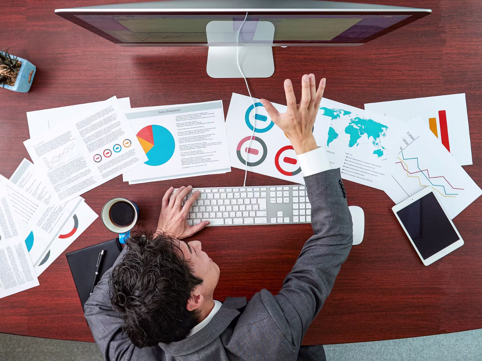 Business professional reviewing sales data and prospect information at a desk