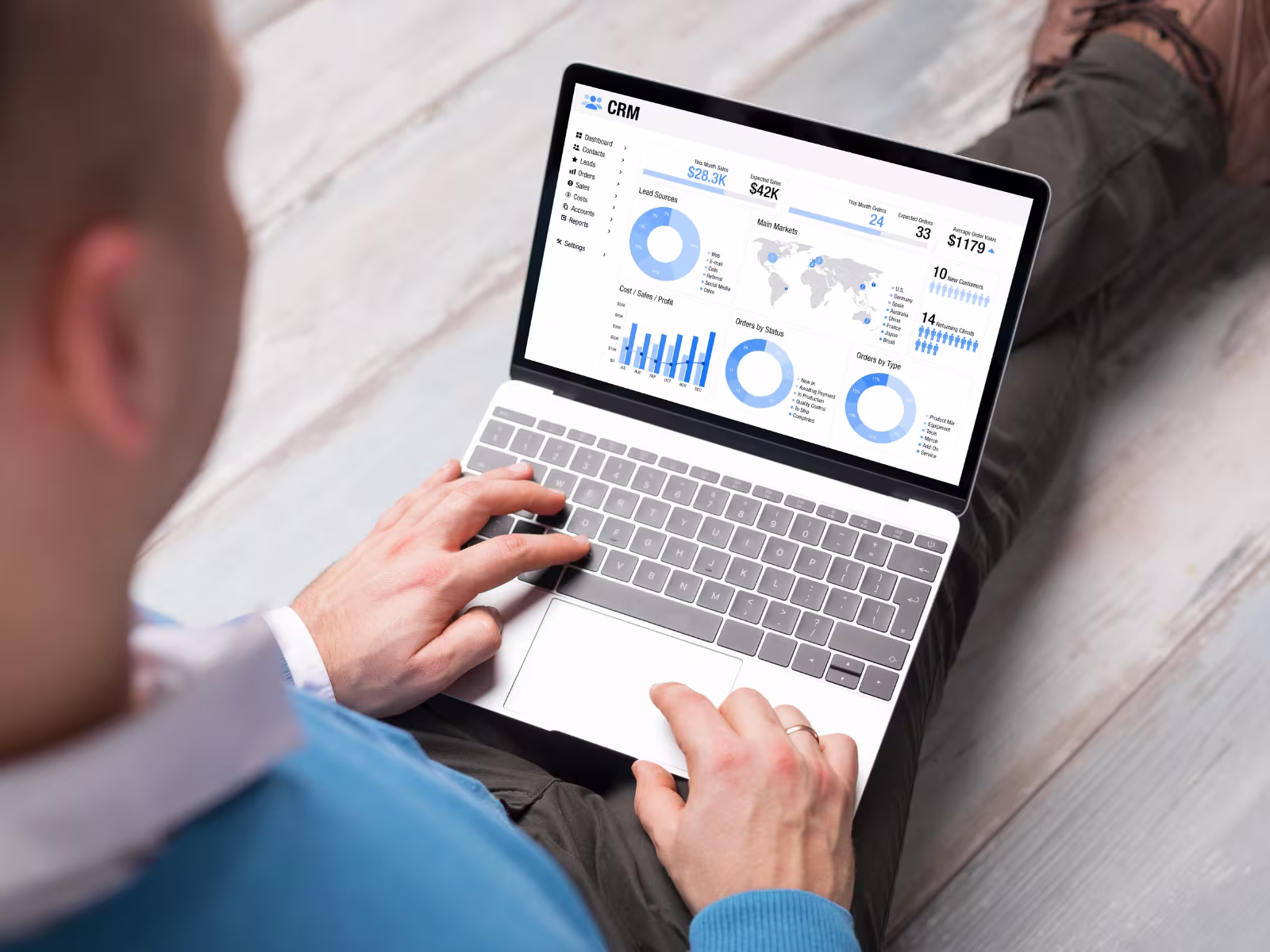 Business professional reviewing sales leads and CRM data on a laptop