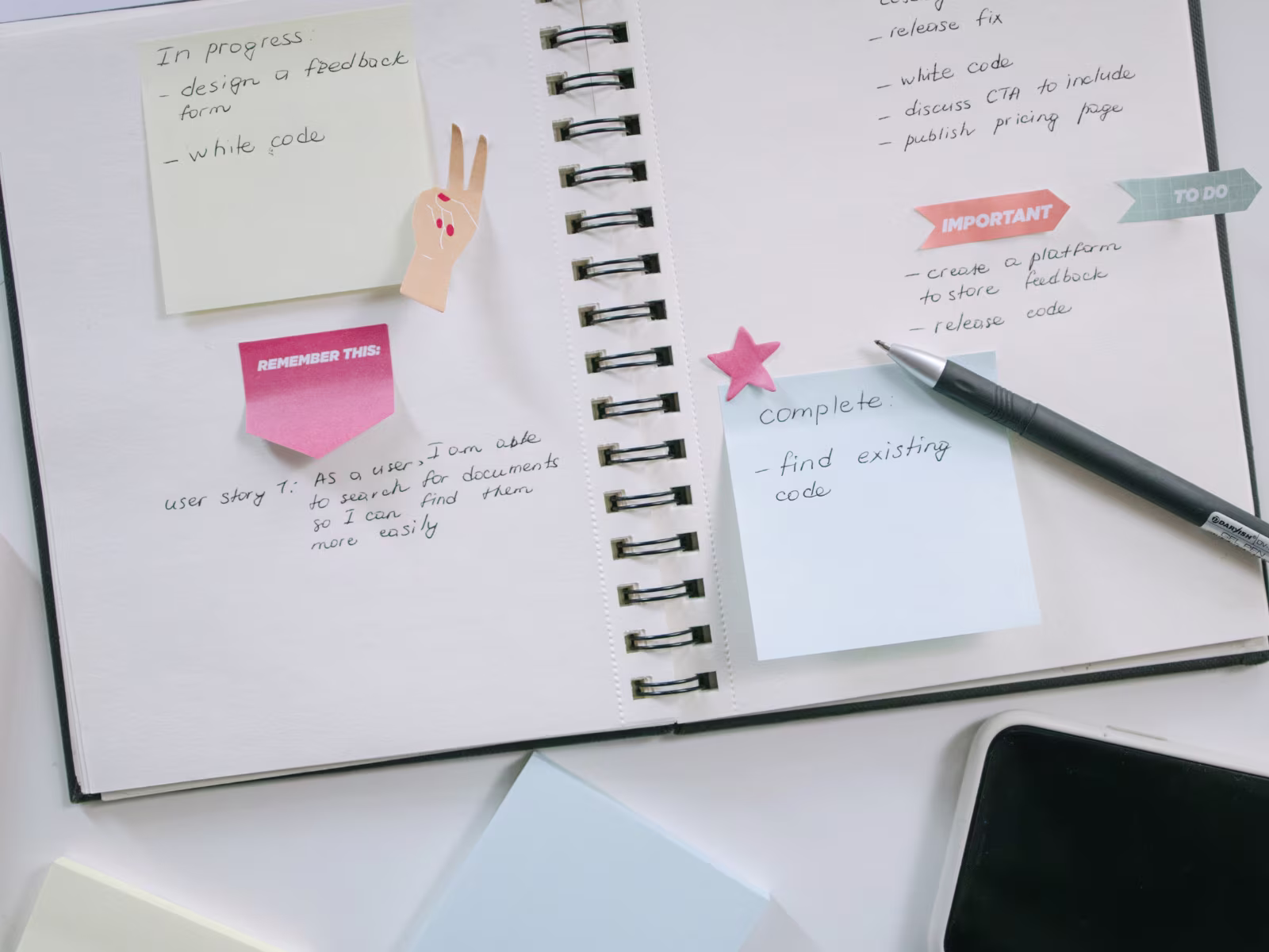 Open planner with handwritten notes and tasks on a desk