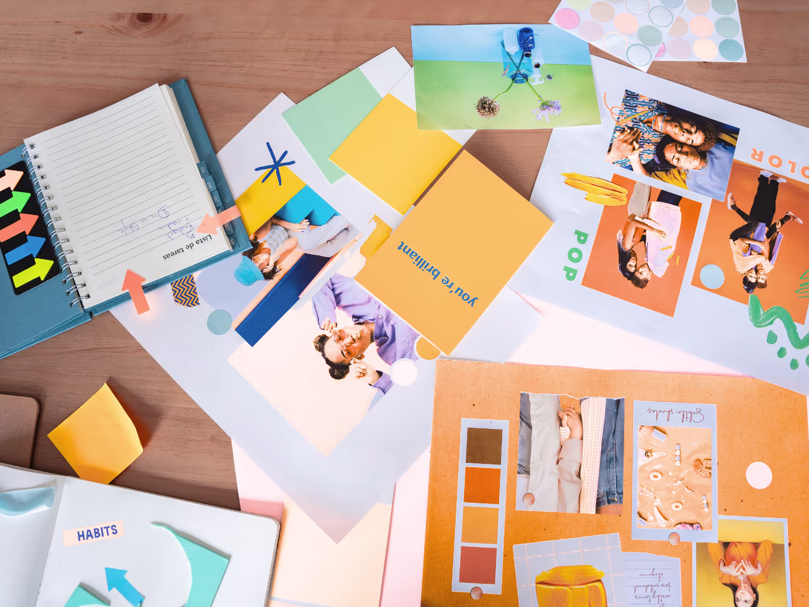 Branding materials, colour palettes and design ideas spread across a desk