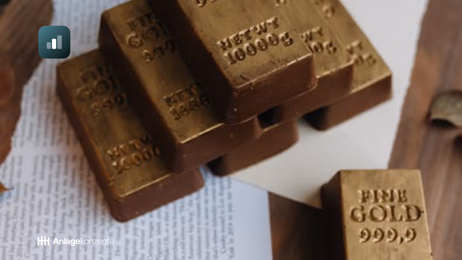 Mehrere goldene Barren auf Finanzdokumenten – Symbolbild für Investition in physisches Gold als Kapitalanlage