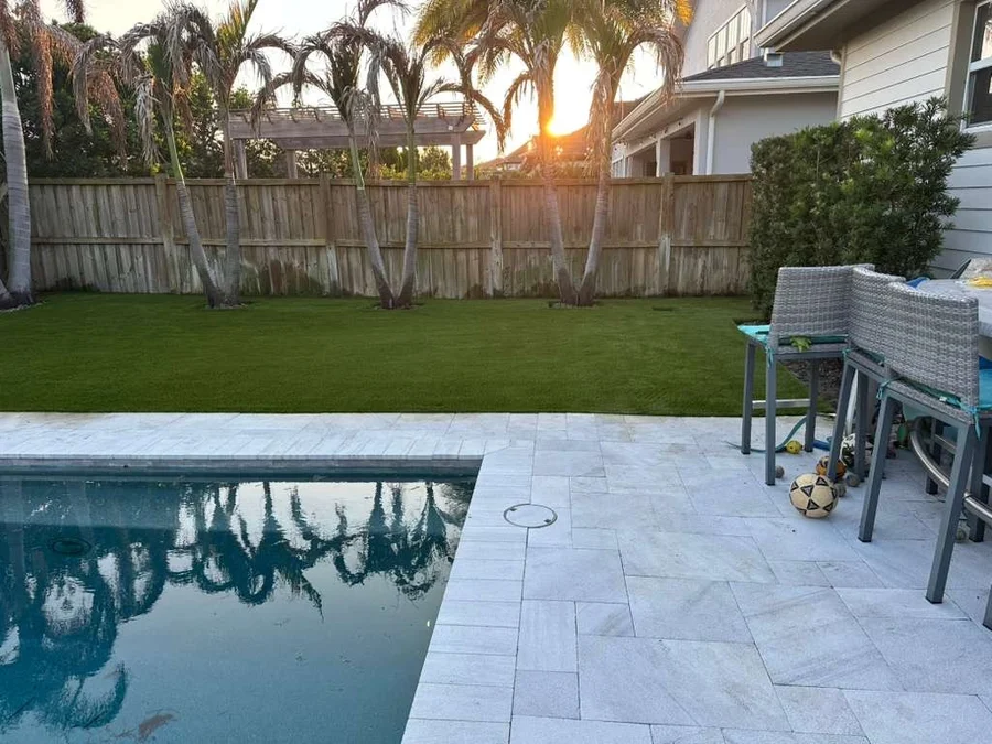 artificial-grass-pool-surrounds-backyard-lawn-beside-paver-pool-deck