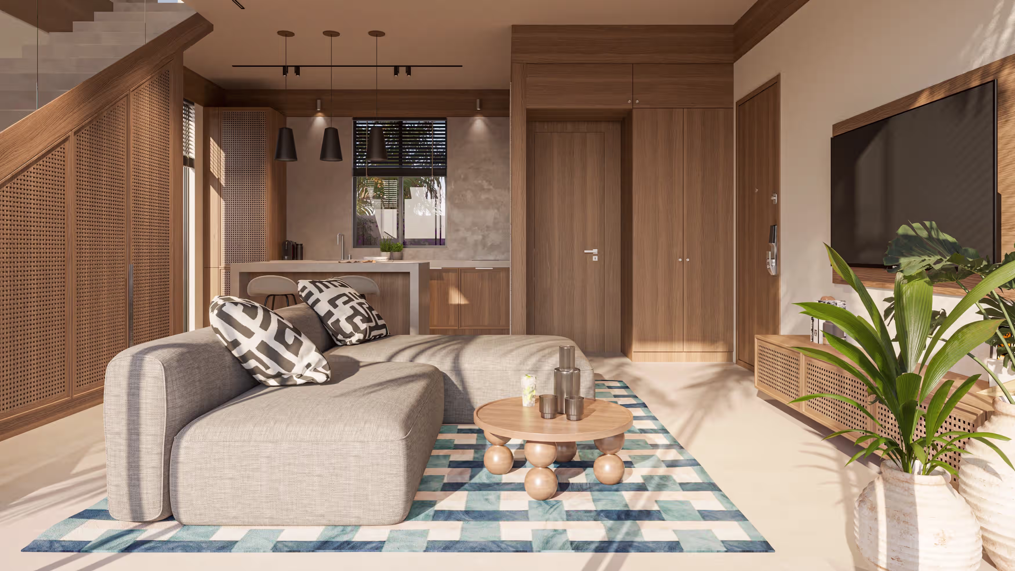Villa living area with corner sofa, patterned cushions and open kitchen behind