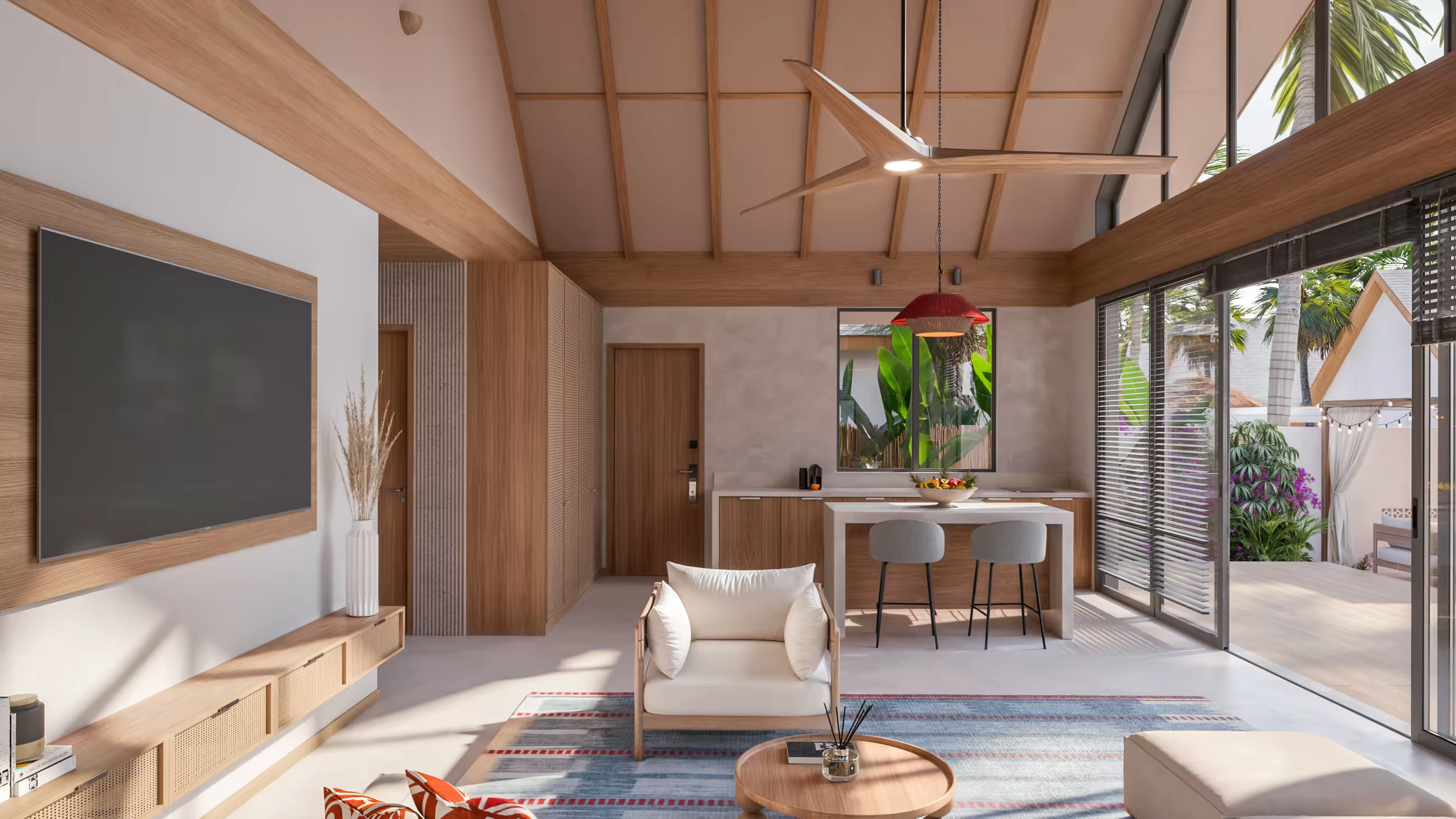 Villa living room with vaulted ceiling and ceiling fan, dining area and glass doors to the garden