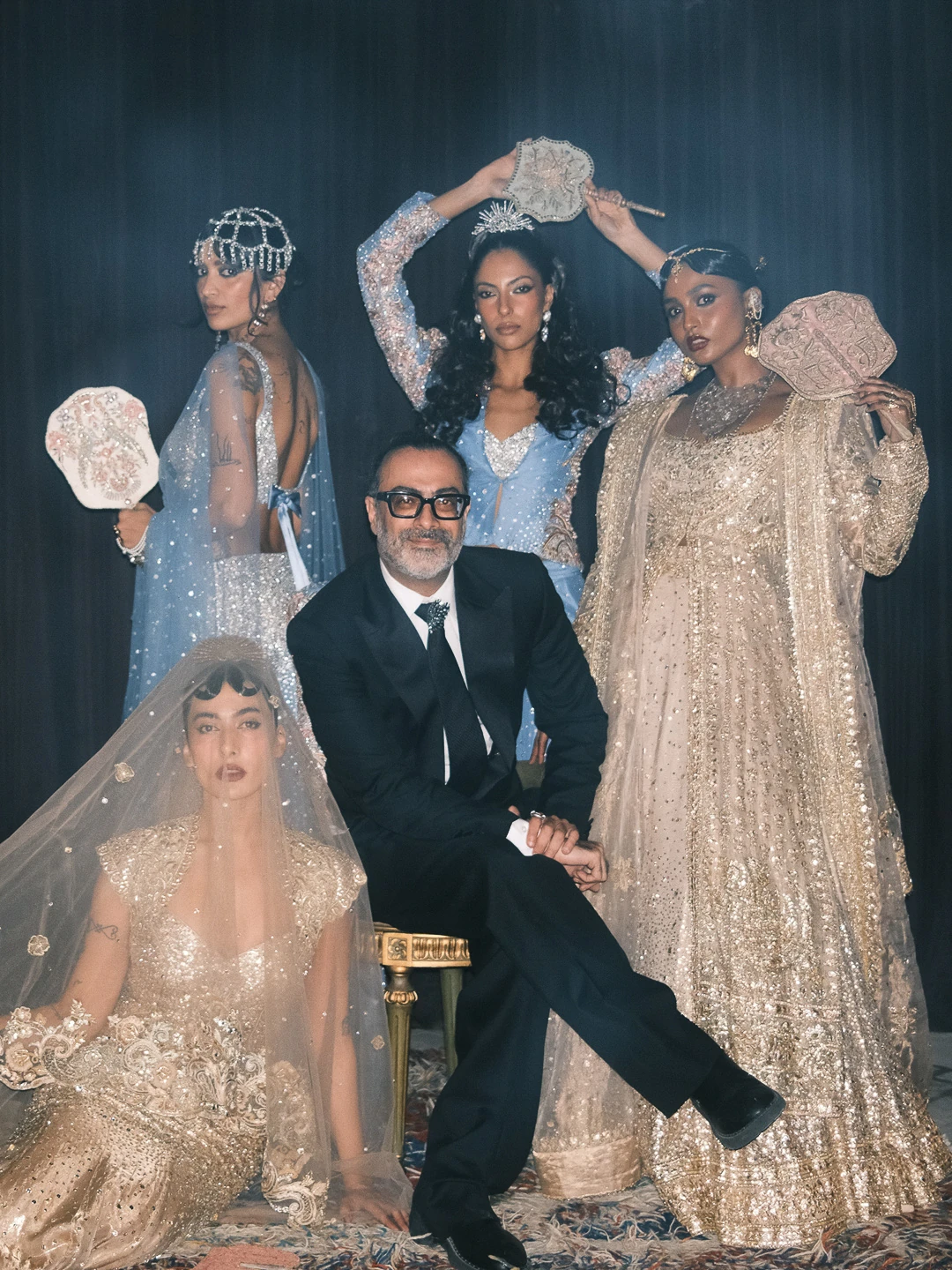 Kamiar Rokni, seated, with four of the House's brides