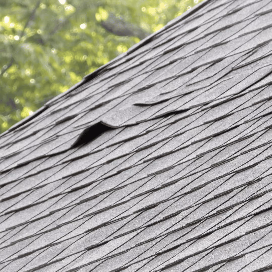 curled roof shingles on damaged roof