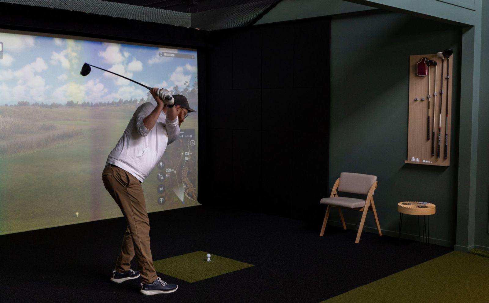 The Croft bay with simulator screen, oak club rack and putting green