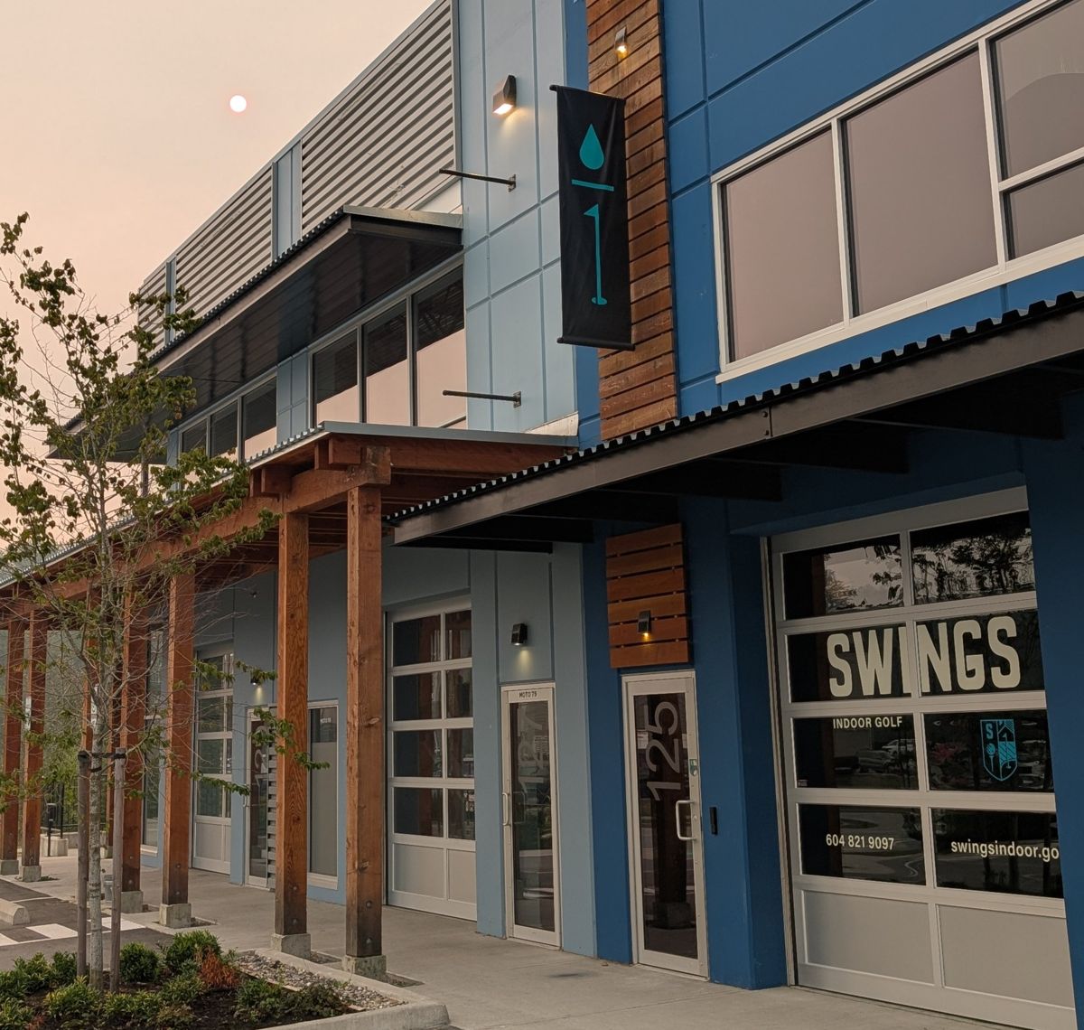 The SWINGS storefront on Discovery Way at sunset