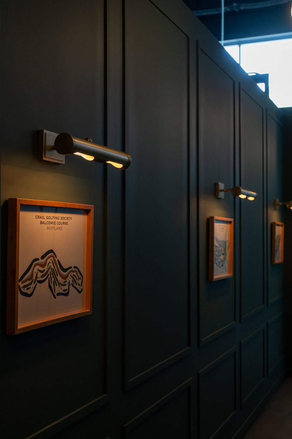 Brass picture lights and framed links course maps