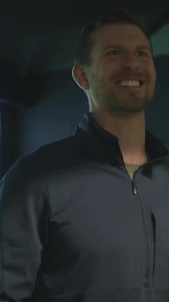 A golfer laughing with friends between shots at SWINGS