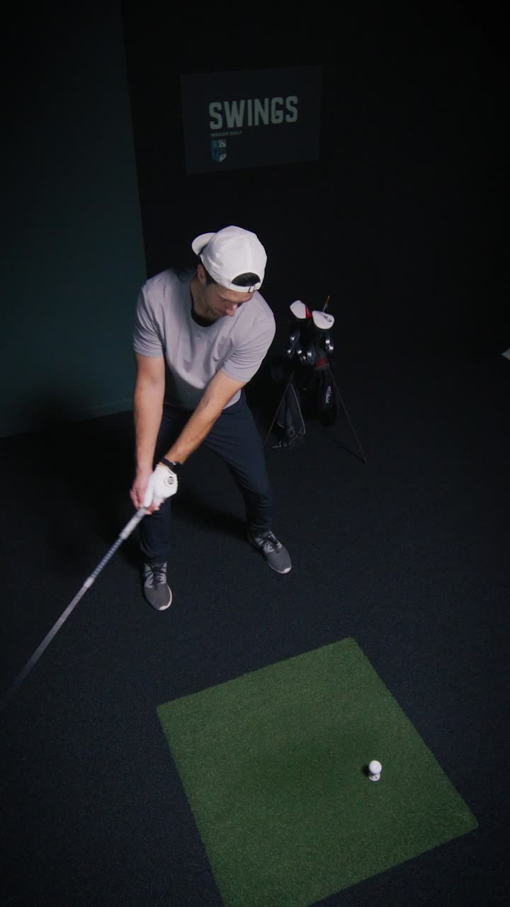 Overhead view of a golfer addressing the ball in a SWINGS bay