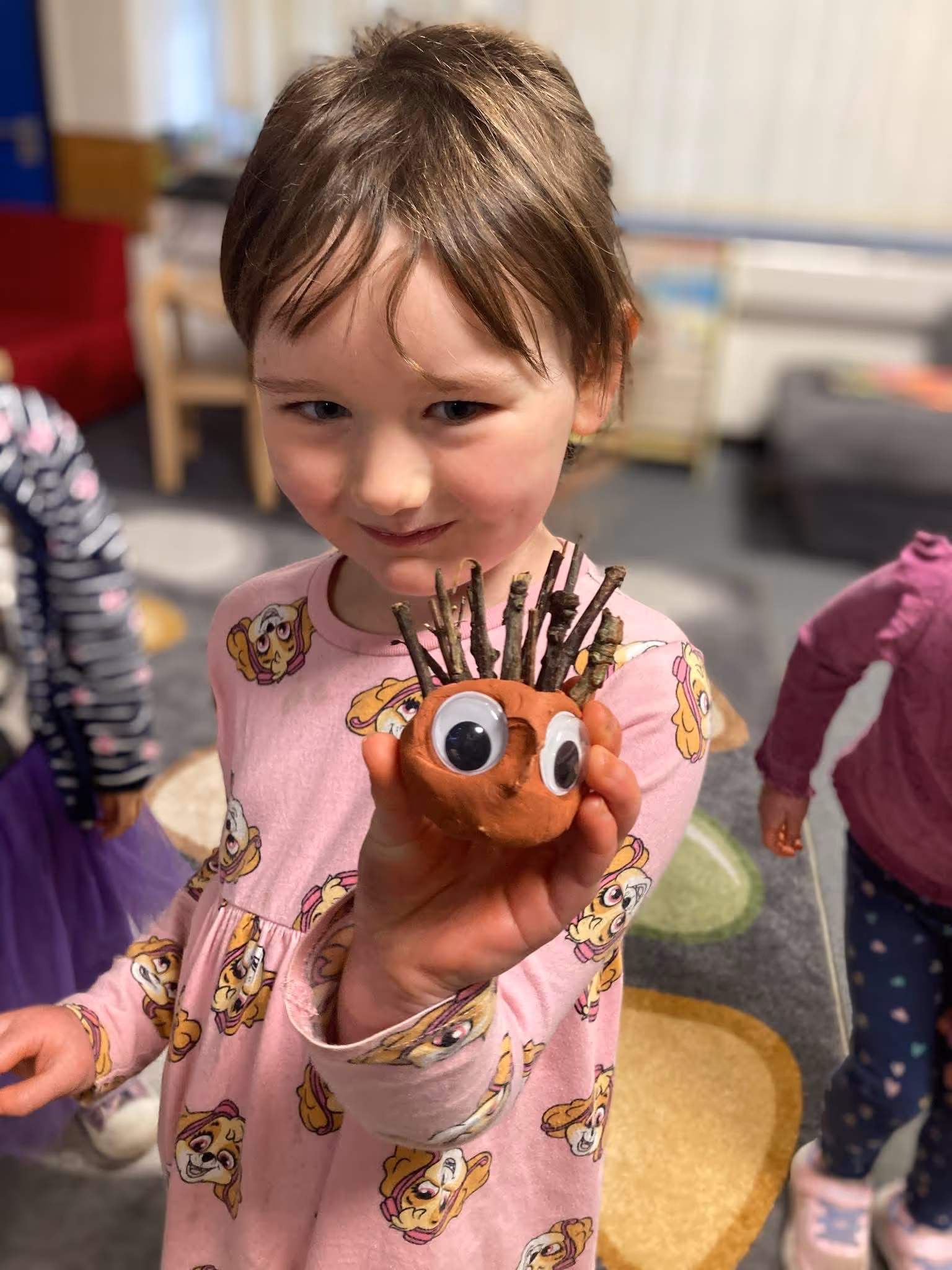 Girl holding craft hedgehog 