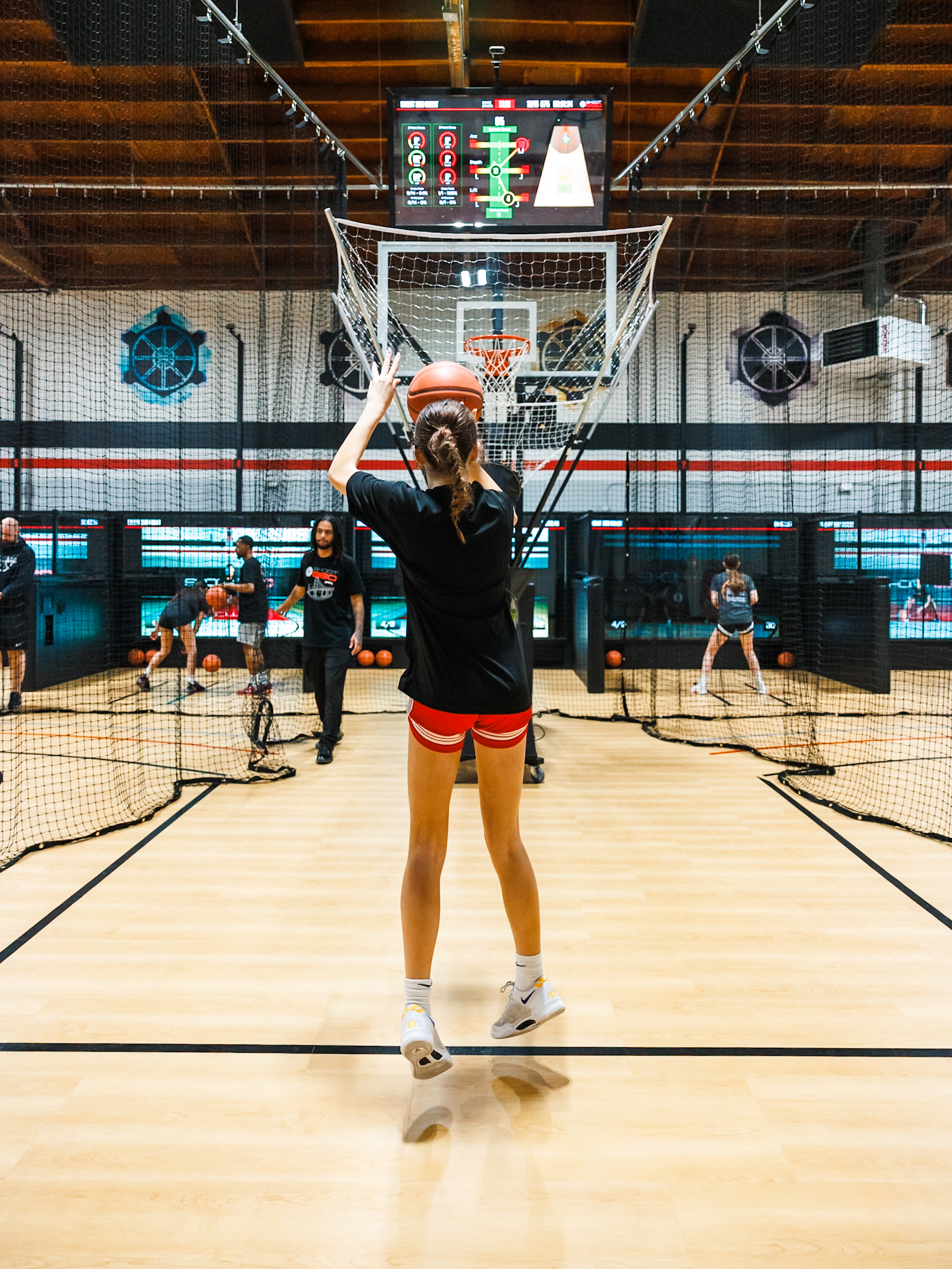 Basketball player using advanced shooting station to improve shot accuracy at Shoot 360 San Mateo.