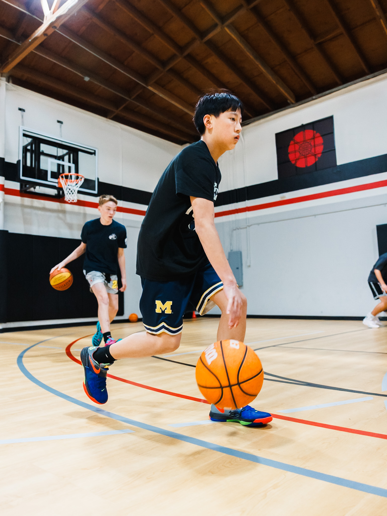 Group of basketball players working together to improve their skills during a training session at Shoot 360 San Mateo.