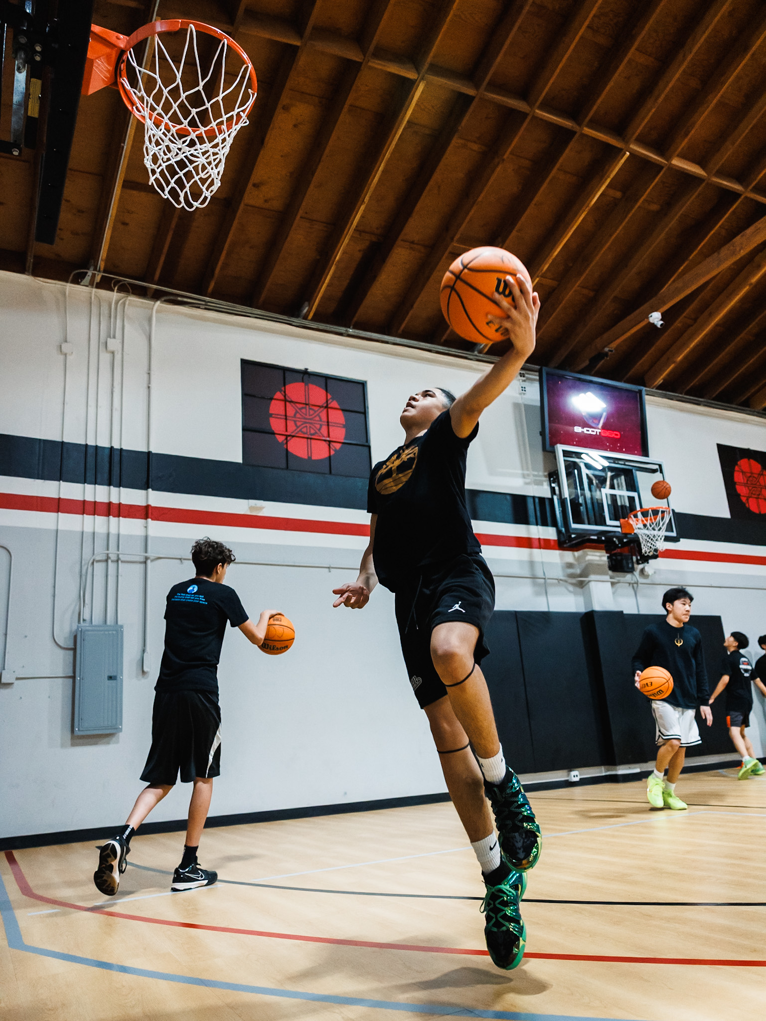 Children enjoying basketball games and activities during a fun-filled birthday party at Shoot 360 San Mateo.