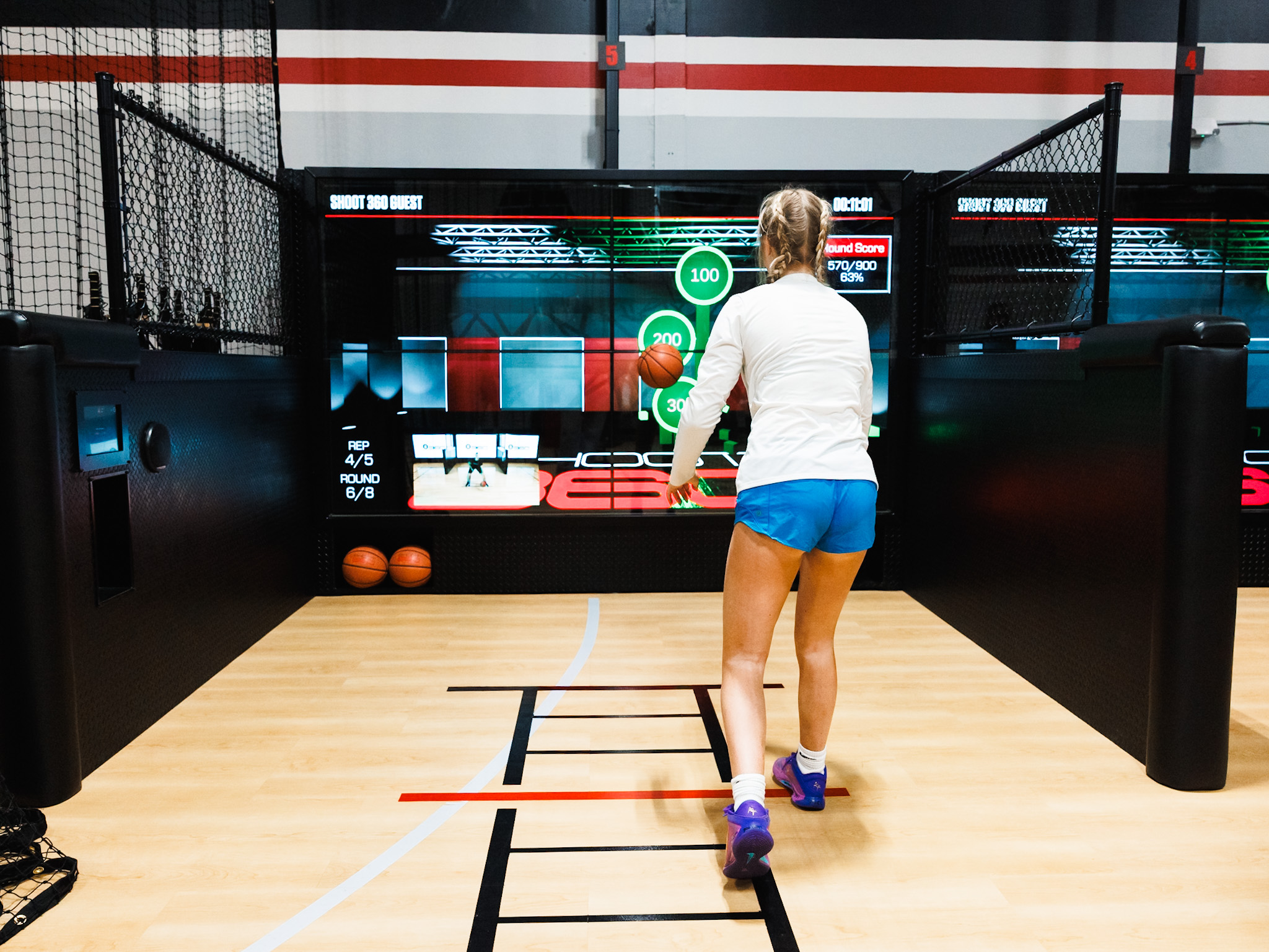 Athletes enjoying a pickup game on the basketball court at Shoot 360 San Mateo, available for hourly rentals.