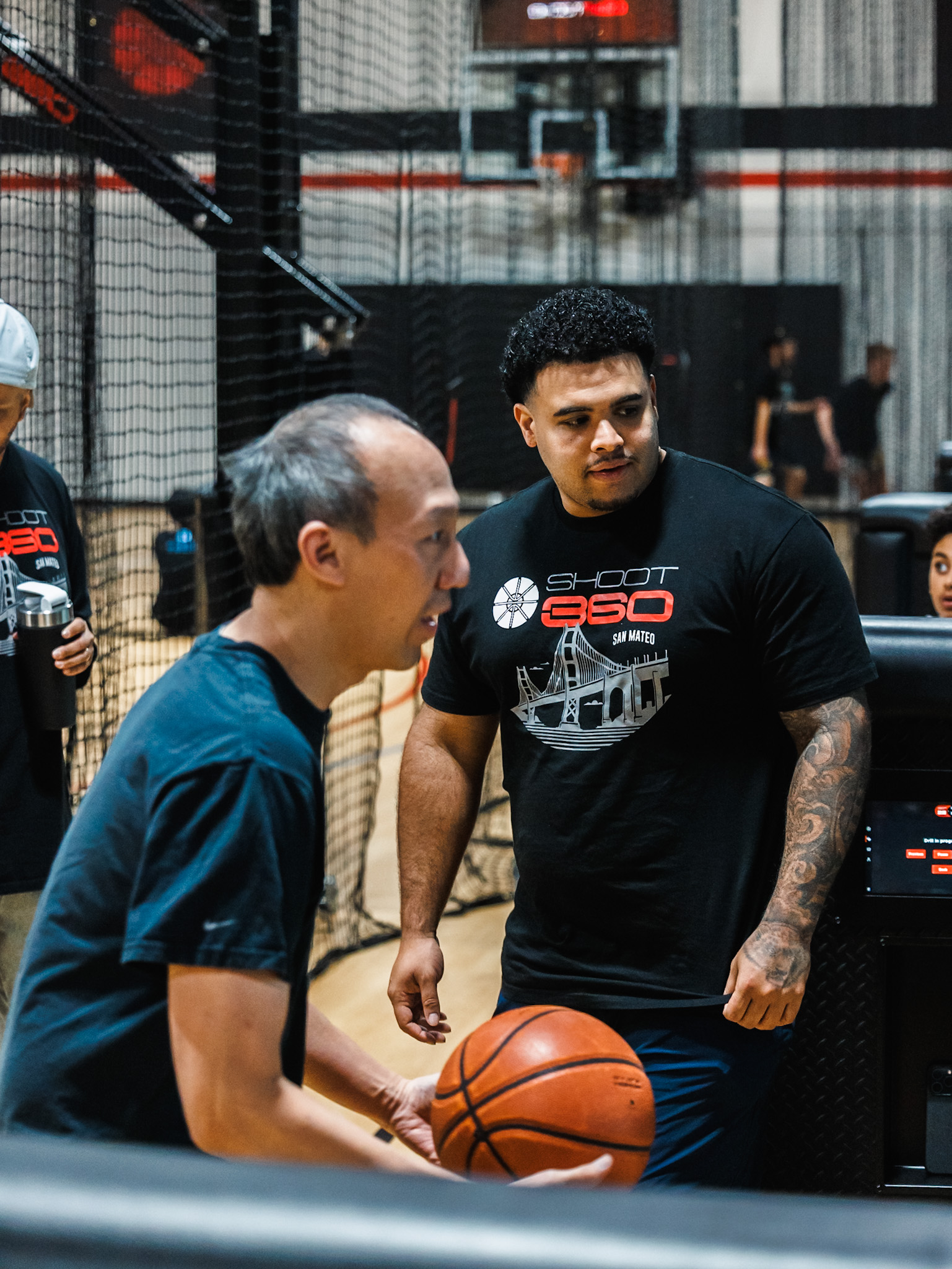 Shoot 360 San Mateo membership benefits displayed with players training and improving their basketball skills using advanced technology.