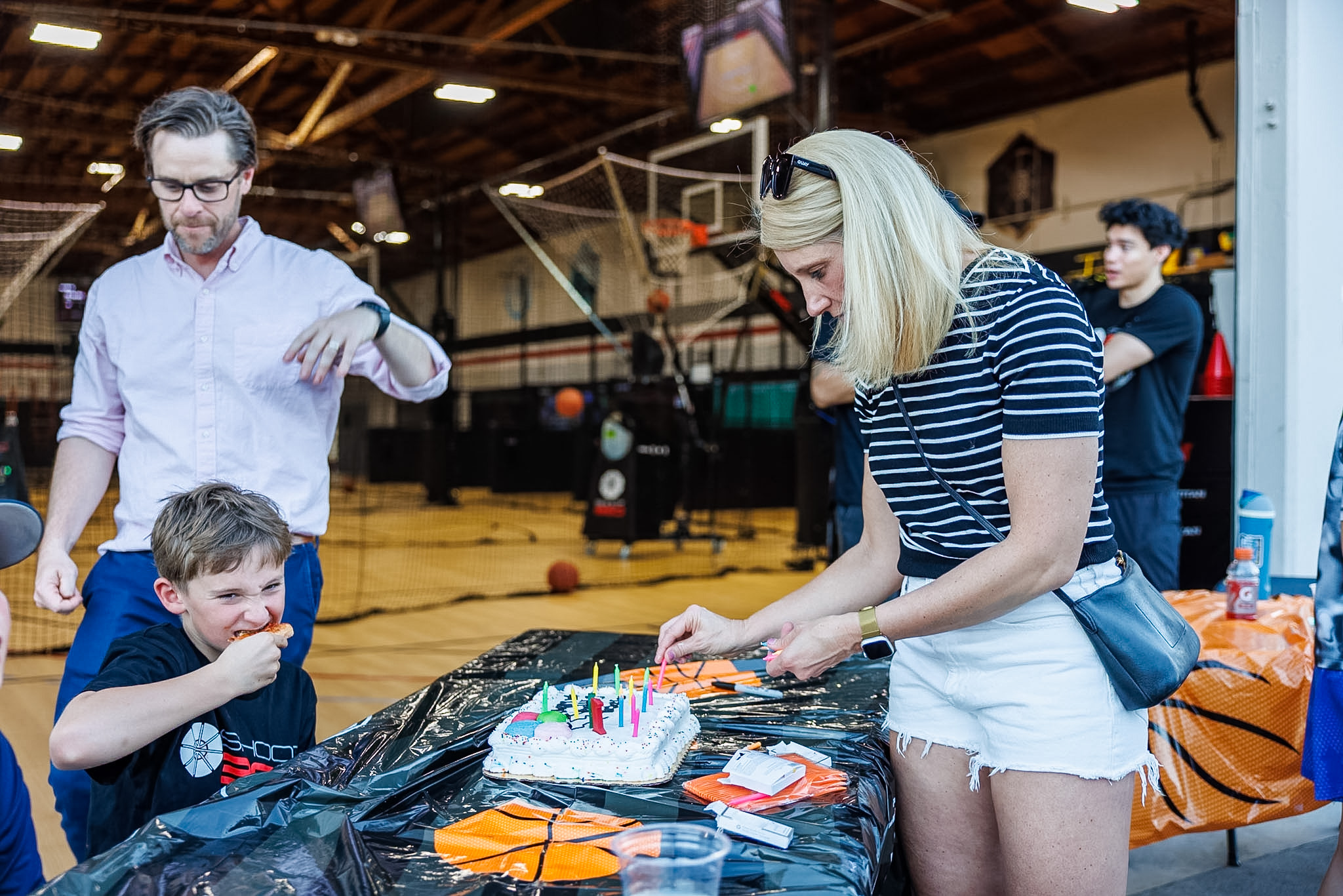 Birthday child and guests celebrating their special day with a group photo at Shoot 360 San Mateo.