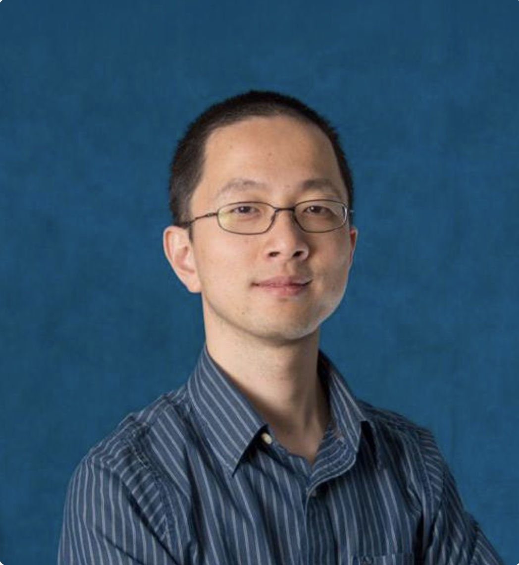 Dr. Yue Ke, CTO & Co-founder. Pictured: Portrait of a man with short black hair and glasses wearing a blue striped shirt against a blue background.
