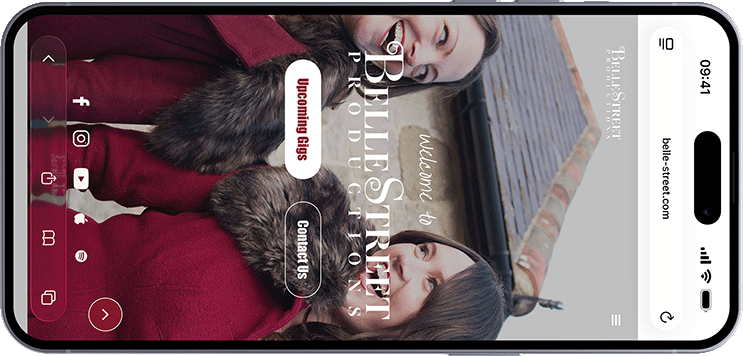 Mobile phone screen showing Belle Street website with two smiling women in red coats with fur collars.