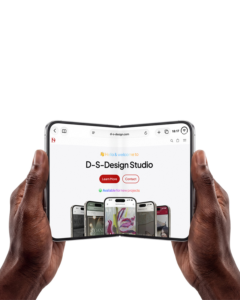 Hand holding smartphone displaying D-S-Design Studio website with Learn More and Contact buttons.