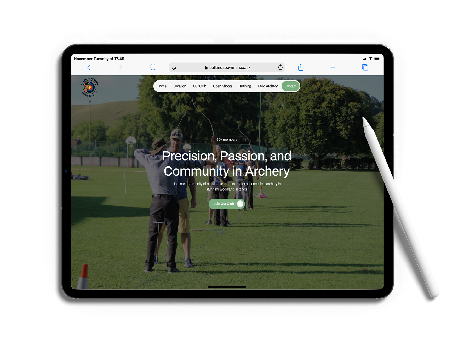 Laptop displaying the Ballands Bowmen Archery Club website featuring a green woodland-inspired design and archery imagery.