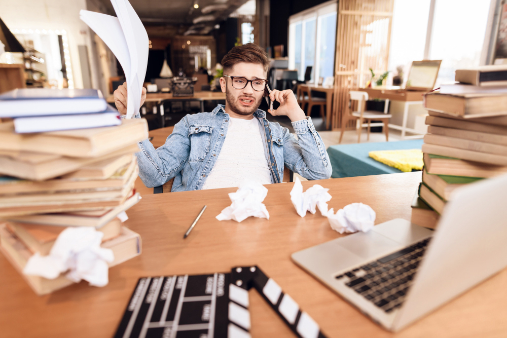 Small business owner frustrated while trying to fix a DIY website on a laptop.