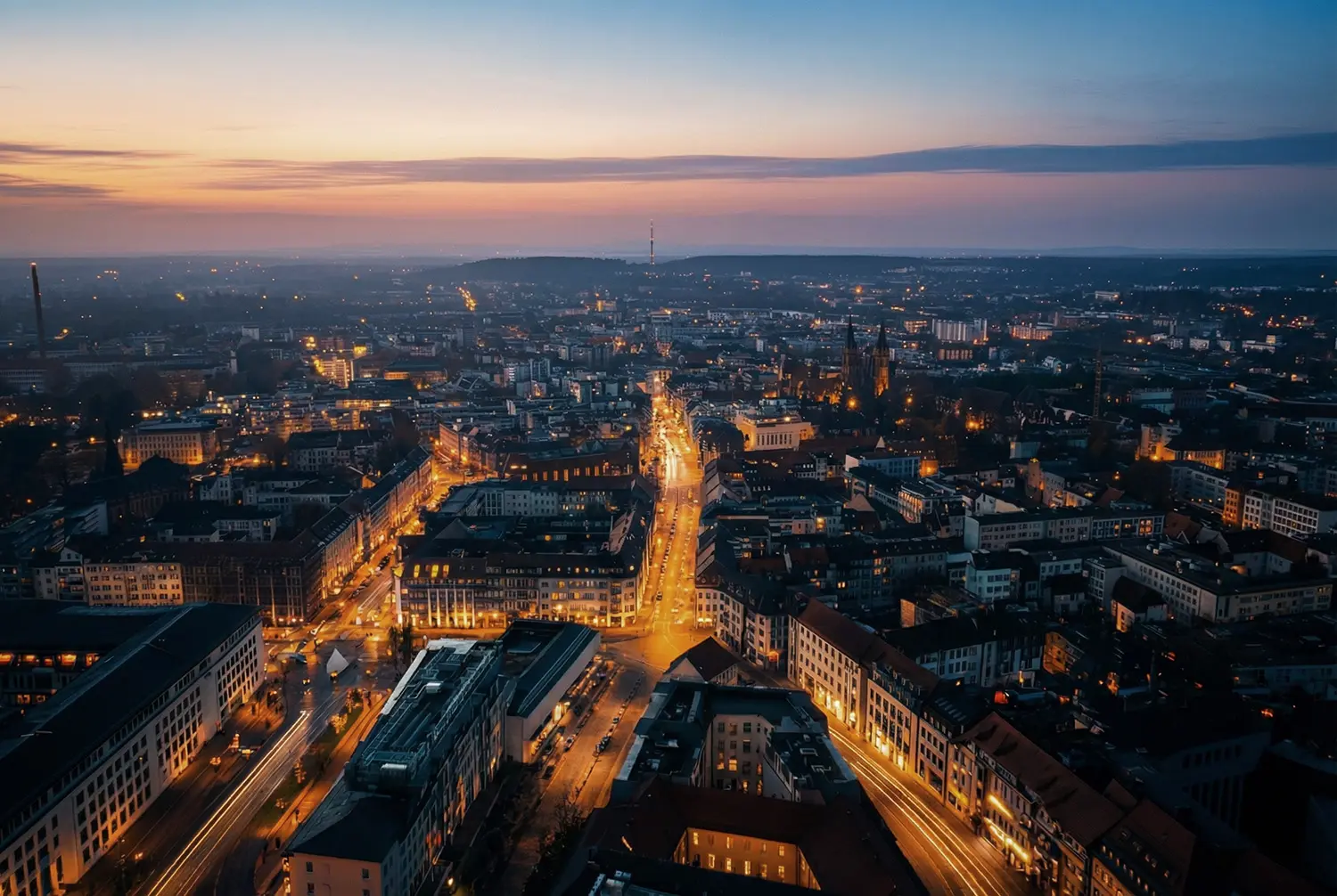 Panorama-Luftbild einer erleuchteten Stadt in der Dämmerung.